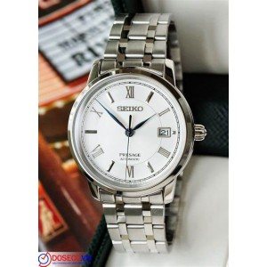 SEIKO HORLOGE PRESAGE AUTOMAAT STALEN BAND EN KAST, WITTET BLAUWE PLAAT MET ROMEINSE CIJFERS EN DATUM EN SAFFIERGLAS 100M - 79383 - SRPC05J1